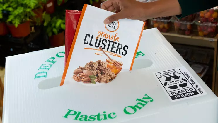 plastic packaging being placed in a Plastic Only recycle bin